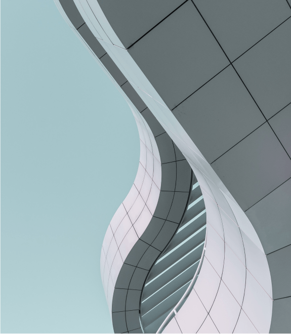 A stunning curved building against a vibrant blue sky.