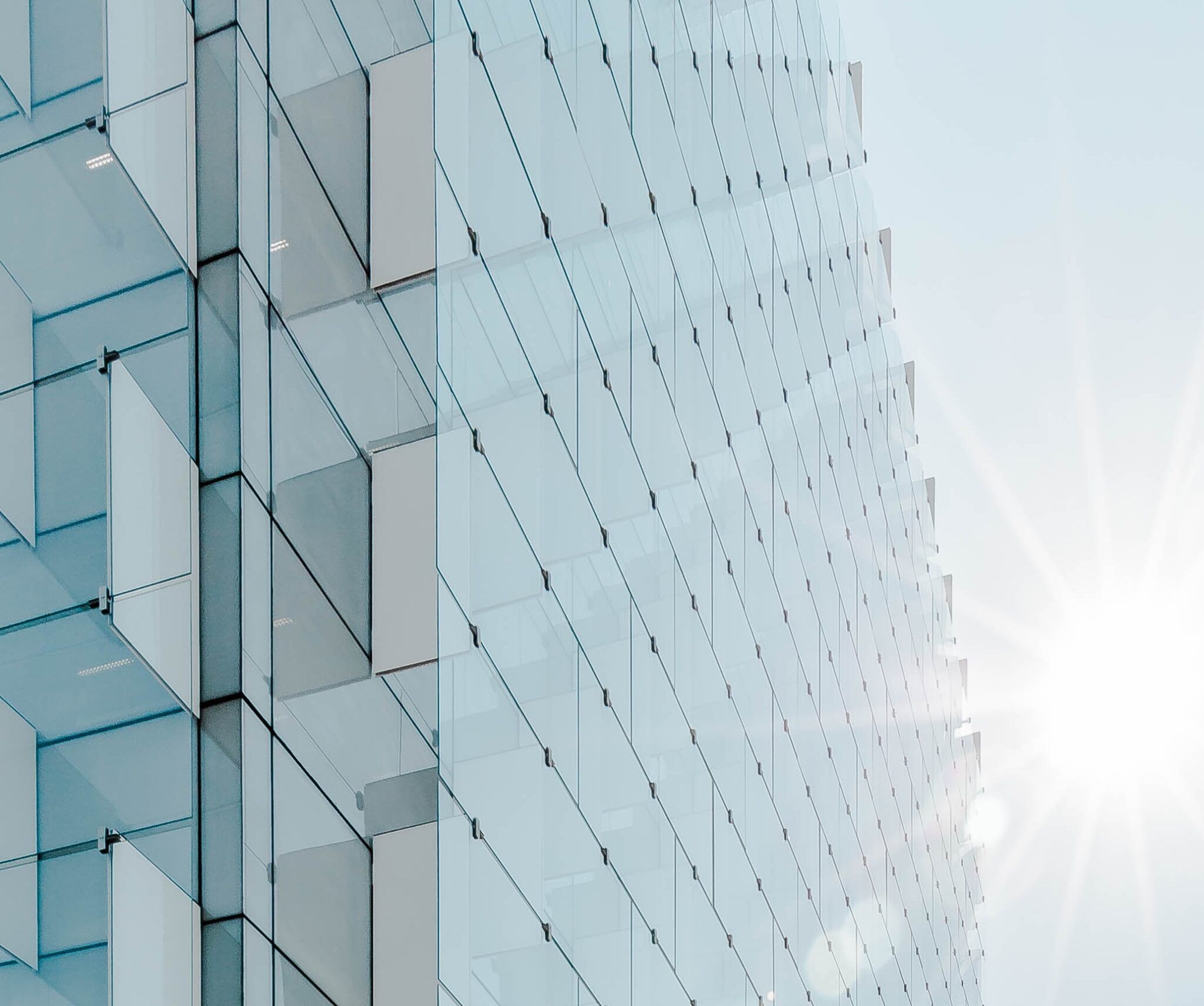 a glass building with sun shining through it